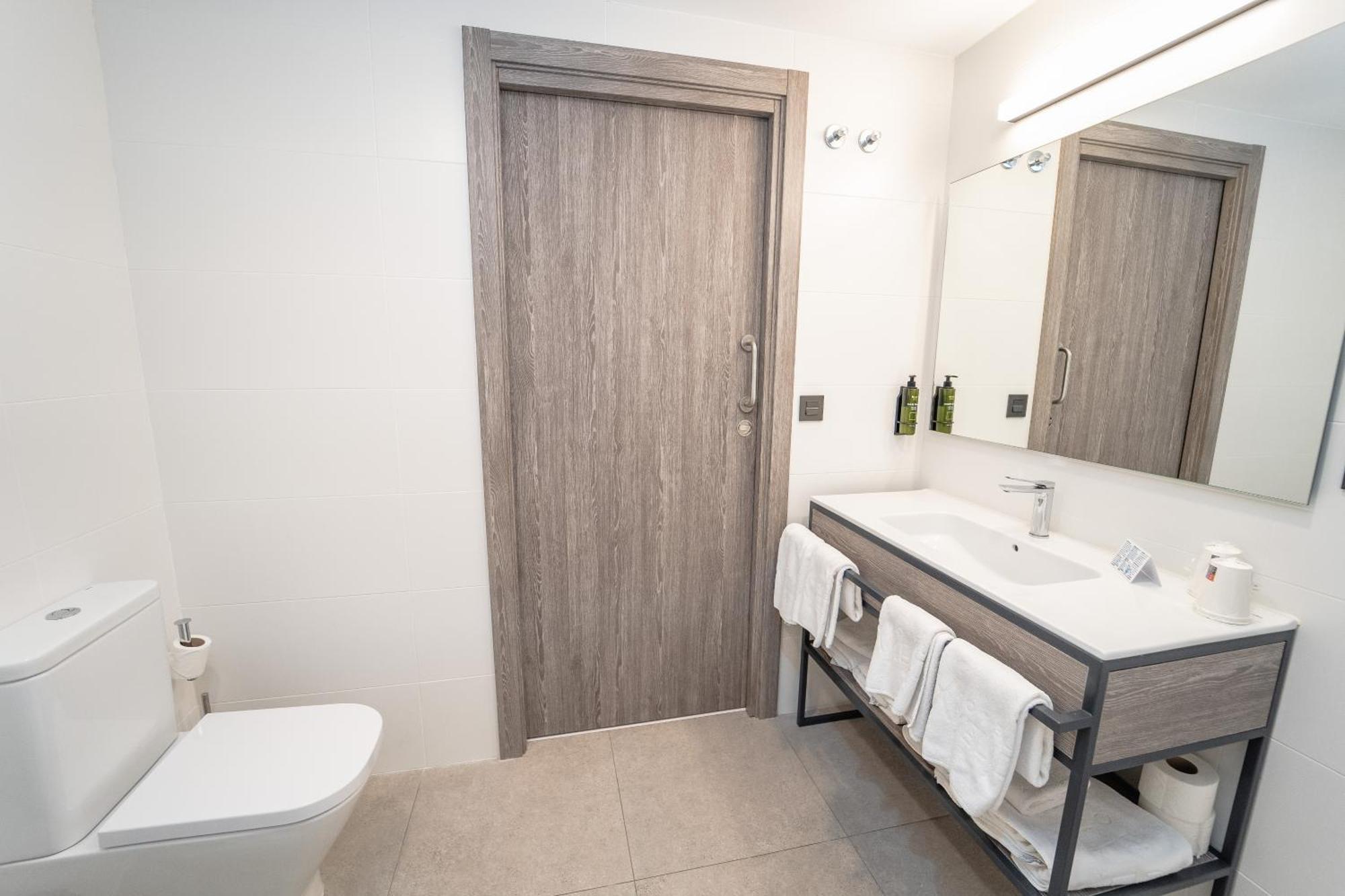 Hotel Lux Melide Pokoj fotografie